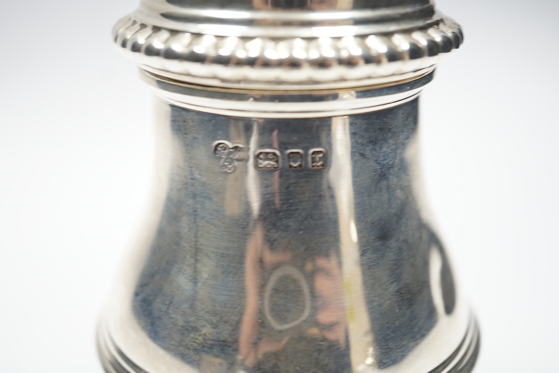 A George V silver baluster sugar caster, Harrod's Ltd, London, 1931, 20.2cm, 9.8oz.